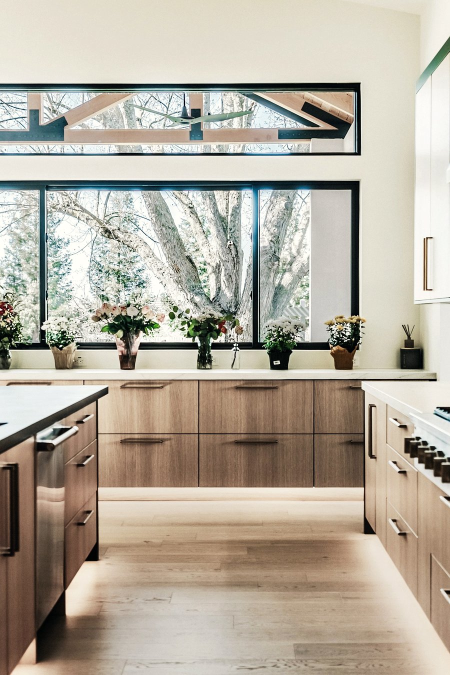A fitted kitchen with a run of units under a window