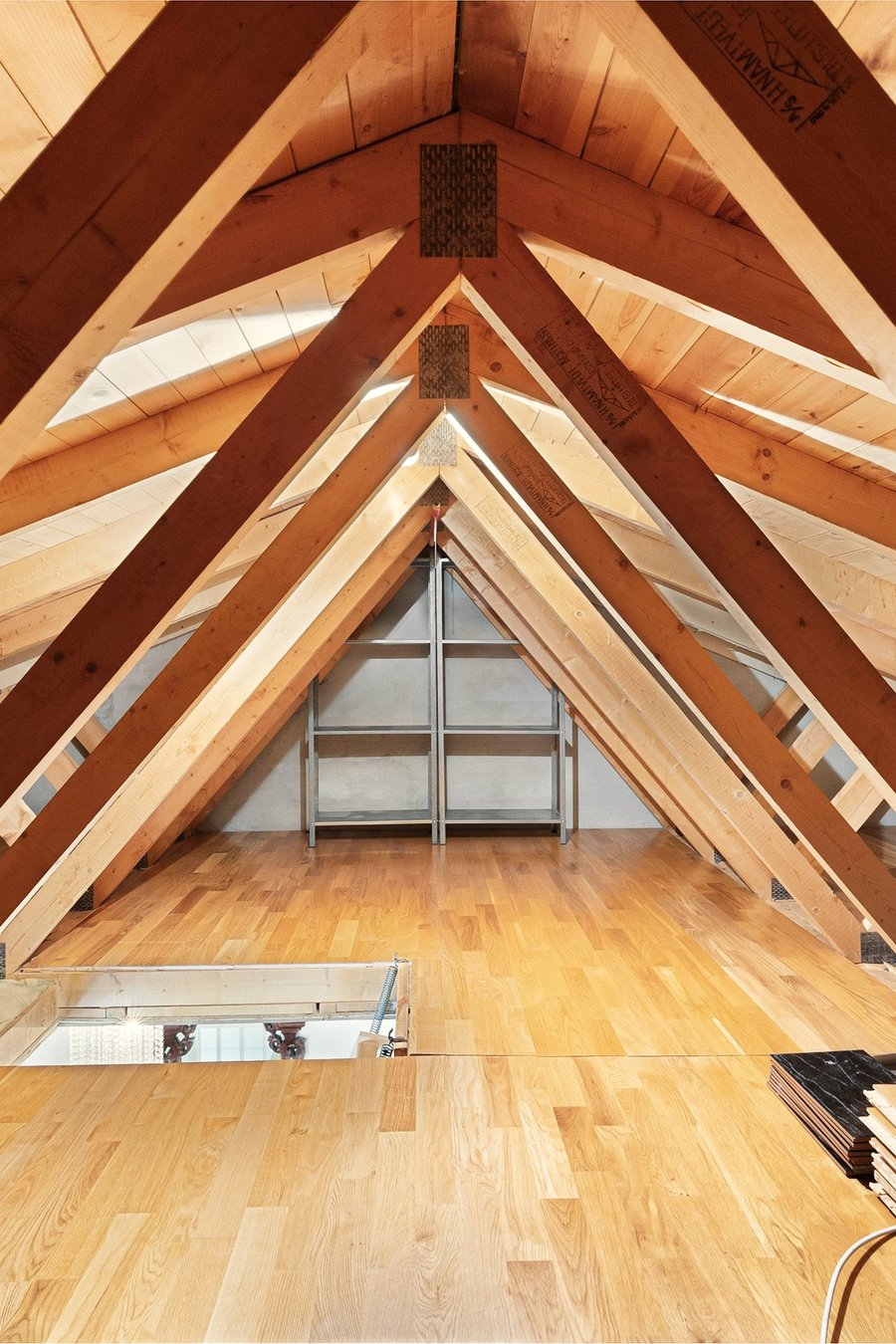 A converted loft with exposed timber trusses and a rooflight